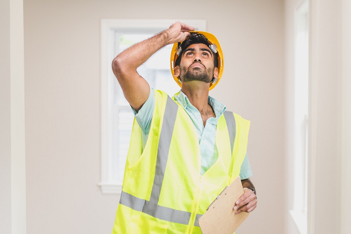 A man inspecting a home.