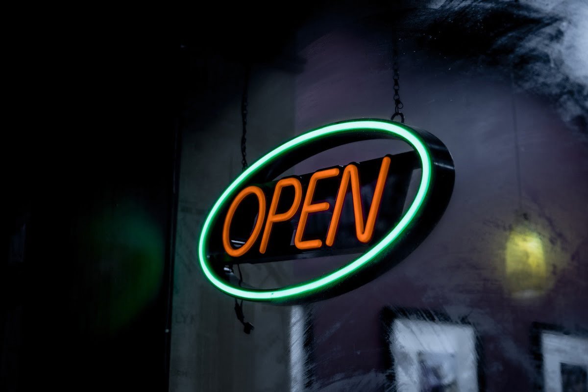 Photo of a neon sign saying open.